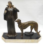 A French Art Deco painted spelter and ivorine sculpture of a standing lady in long dress and cloak