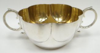 A silver twin-handled bowl of fluted form and with scroll-handles, London 1895, maker's mark for