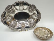 An elaborate oval silver basket with pierce-work and floral repousse, London 1862, 7ozs; together