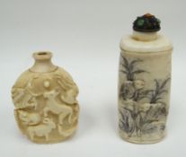 An ivory snuff bottle carved with animals in relief, character marks to base, 2.25ins high (6cms);