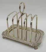 A pretty four-section silver toast-rack with loop handle above and gadrooned base upon acanthus