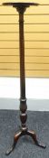 A mahogany tripod torchiere with fluted long column, 60ins (153cms)