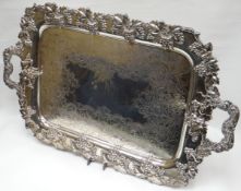 An impressive EPNS twin-handled tray having fruit-on-vine border, handle and raised on four fruit-