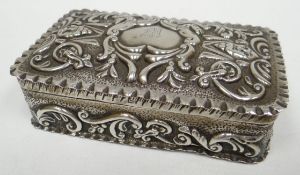 A silver box all-round decorated with repousse work and having an engraved letter 'm' to the