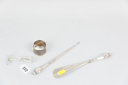 A silver pusher spoon, 0.9ozs, Birmingham 1913 (inscribed), a plain silver napkin ring, 0.5ozs,