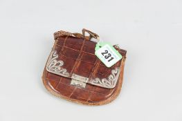A ladies Edwardian crocodile purse with imported silver clasp and corner scrolled mounts