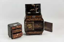 An early 20th Century Japanese lacquerwork table cabinet with white metal mounts and fittings,