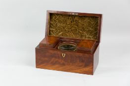 A Regency mahogany tea caddy with brass carrying handle and escutcheon, the re-lined velvet interior