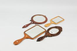 A small collection of wooden hand mirrors incl. a fretwork and inlaid olive wood example, a