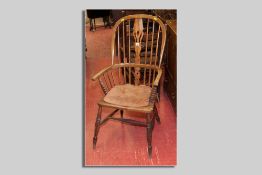 An elm Windsor splat and spindlebacked elbow chair with turned supports and centre stretcher