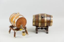 An oak corked brandy barrel on stand with plated metal bands and mounts along with a naive example