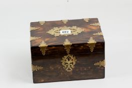 A Victorian rosewood tea caddy with numerous brass edge mounts, central pierced lid cartouche and