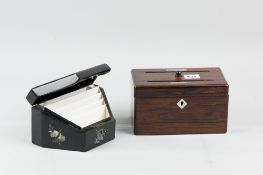 A shaped papier mache lidded stationery box with mother of pearl inlay and multi-section interior,