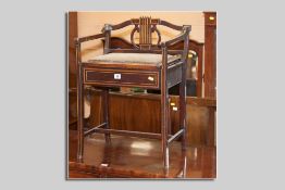 An Edwardian mahogany and boxwood string inlaid music stool with contents, the back with a lyre