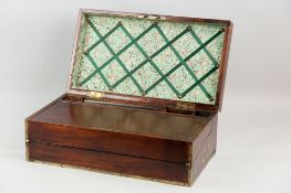 A nineteenth century mahogany and brass bound lap desk with double-hinged lid and slope with