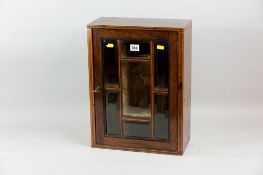An Edwardian rosewood and boxwood line inlaid display cabinet, the single opening door with seven