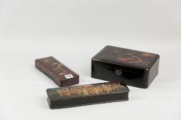 An Oriental lacquerwork lidded box with bird and floral top decoration in red lacquer with gilt