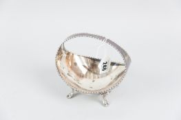 A boat shaped silver basket with centre incorporated handle and on four curved supports with
