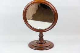 A Victorian mahogany gentleman's shaving mirror, round-framed adjustable mirror on a rise and fall