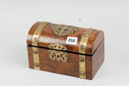 A 19th Century casket shaped figured walnut tea caddy with pierced brass embellishments and