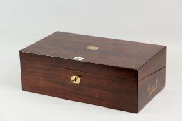 A 19th Century mahogany writing slope with brass plaque and escutcheon, inset brass handle to side