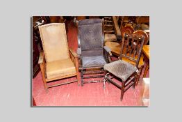 A 1930s oak reclining armchair with leatherette upholstery, an Edwardian American rocker with