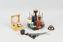 A rosewood cotton reel stand with turned wooden central column and pin cushion top on turned bone