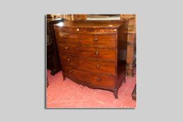 An early Victorian mahogany bow front chest of three long and two short drawers all with turned