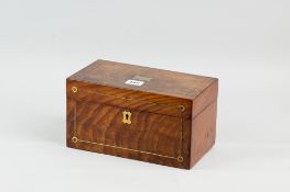 A late Georgian mahogany and brass strung tea caddy having top brass cartouche and escutcheon, the