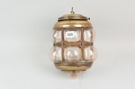 A blown glass lantern type shade in brass and metal frame with detachable bulb holder/ceiling