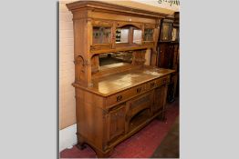 A good solid oak Art Nouveau mirror backed sideboard having an inverted step cornice, central mirror
