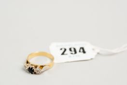 An 18ct gold dress ring with centre amethyst and two tiny floral set flanking diamonds, total 4.8