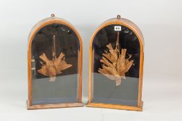 A pair of dome topped mahogany and glass cases containing straw work dead game in possibly