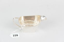 A silver cream jug of plain oblong form with lined rim, 3.2ozs, Birmingham 1954