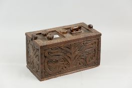An 18th Century carved oak oblong box, the top of the lid having carved symbols and an animal with