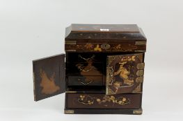 An Oriental lacquerwork tabletop chest with hinged top, central doors with six drawer interior and