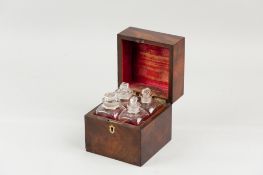 A Victorian mahogany four bottle scent casket, the cube shaped casket with brass escutcheon, the lid