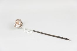 A Georgian silver ladle having an oval bowl with end lip and with a bright cut and shaped insert for