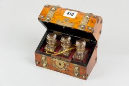 A walnut dome topped scent bottle casket with chased brass strap and button banding, pierced brass