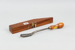 A folding mahogany and brass boot jack fitted with steel boot pulls , 30 x 5 cms, along with a steel
