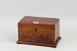 A late Georgian flame mahogany tea caddy of rectangular form on extended moulded base with turned