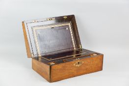 A fine mahogany and brass edged gentleman's lap desk with well maintained interior and two ink