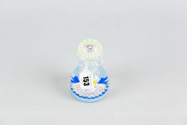 A millefiori bottle paperweight by John Deacons, blue base canes with central thistle decorated