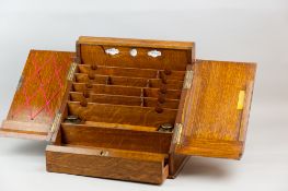 A well-fitted golden oak stationery cabinet, twin opening doors and sliding bottom drawer, hinged