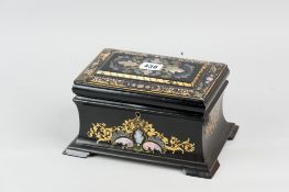 A 19th Century papier mache tea caddy of sarcophagus form inlaid with mother of pearl, enamel