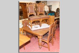 An excellent Edwardian oak dining table and six chairs, a wind-out dining table with two extra