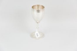 A circular based silver trophy cup, the base having a band of bright cut delicate scrolling repeated