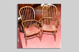Two near matching Windsor elm spindlebacked elbow chairs with turned ring supports and cross