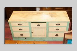 A Victorian painted pine kitchen dresser base, plain railback painted top over three frieze