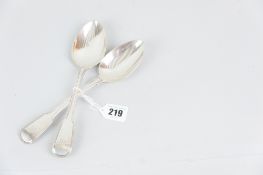 A pair of Georgian silver serving spoons with fiddle pattered and double lined handles with